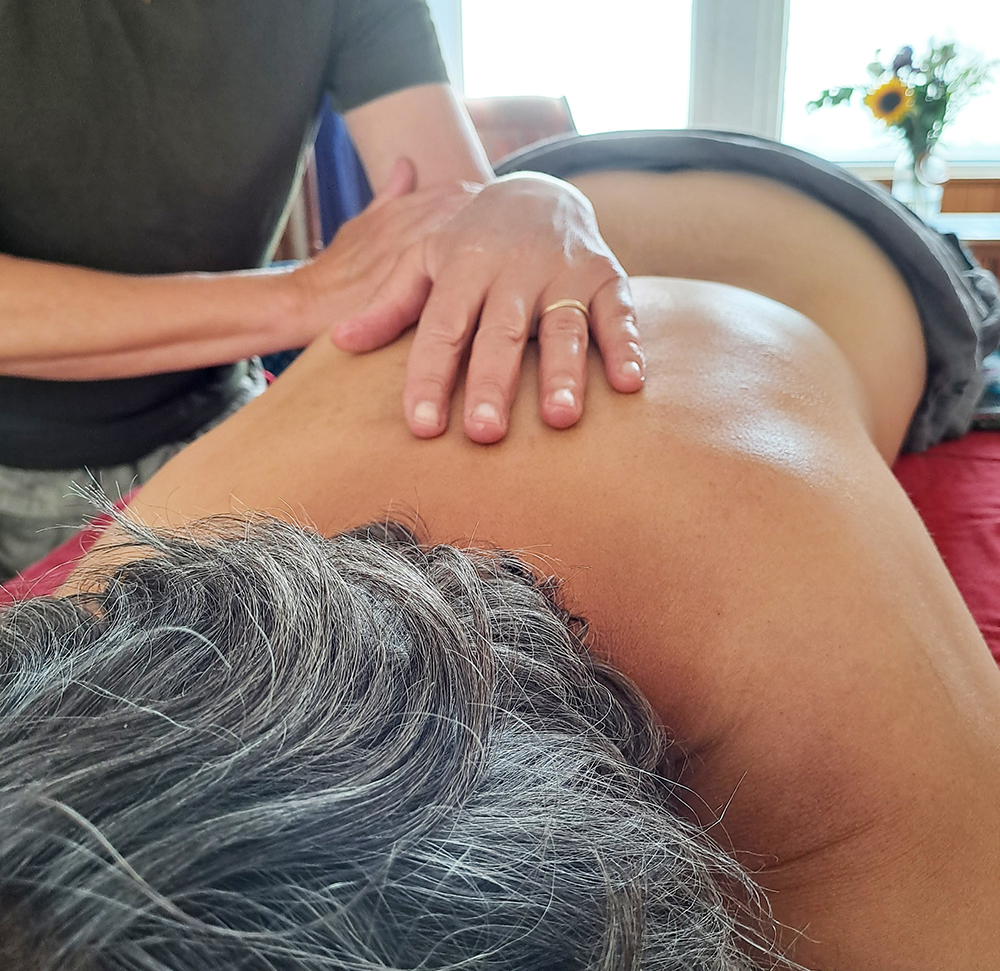 A person getting a back massage on a massage table